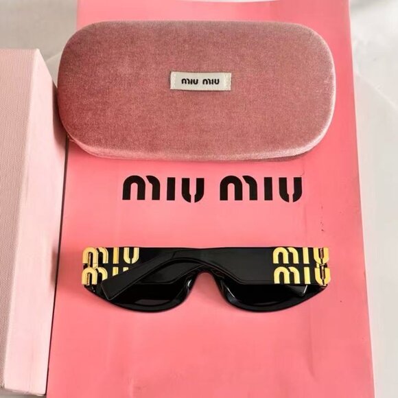 Miu Miu black sunglasses featuring elegant gold accents main image 6